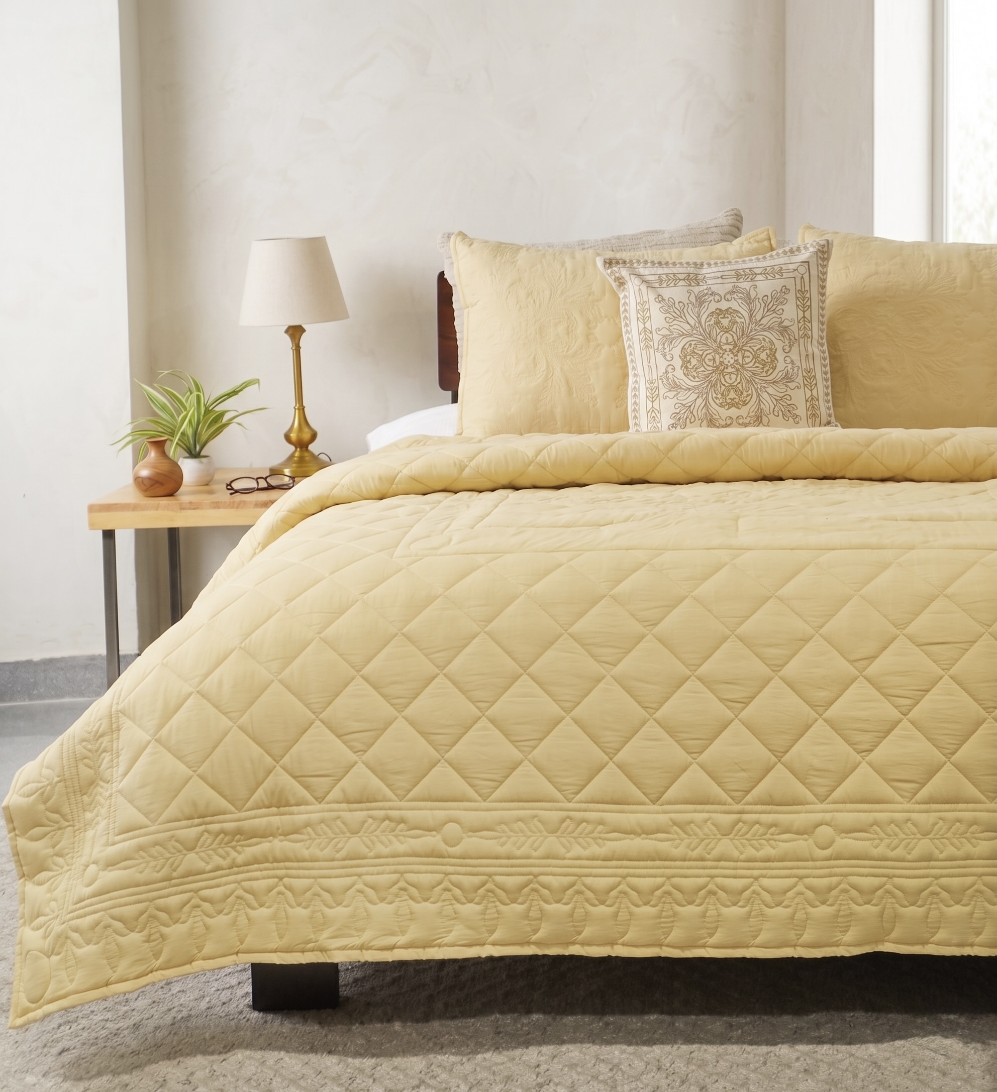 Butter yellow diamond quilted bedspread with chain stitch floral border and embroidered shams