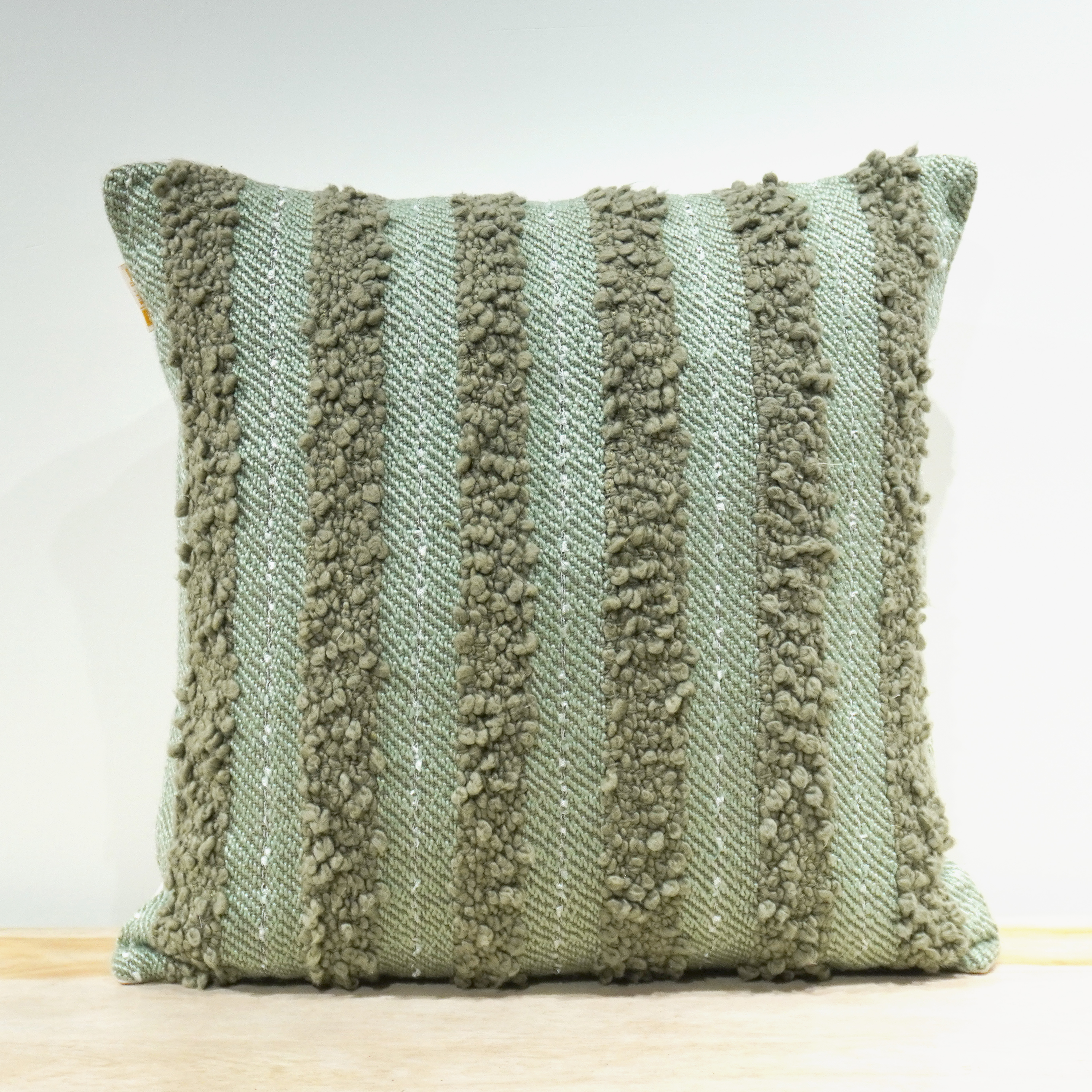 Sage green chenille stripe tufted cushion with vertical raised texture