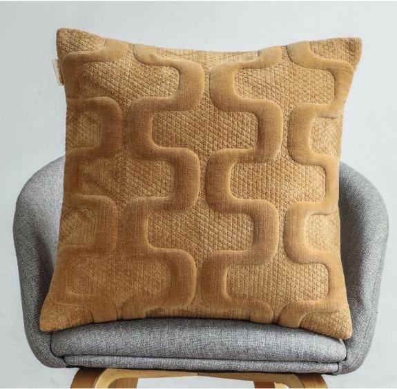 Golden caramel velvet cushion with raised 3D geometric maze interlocking pattern