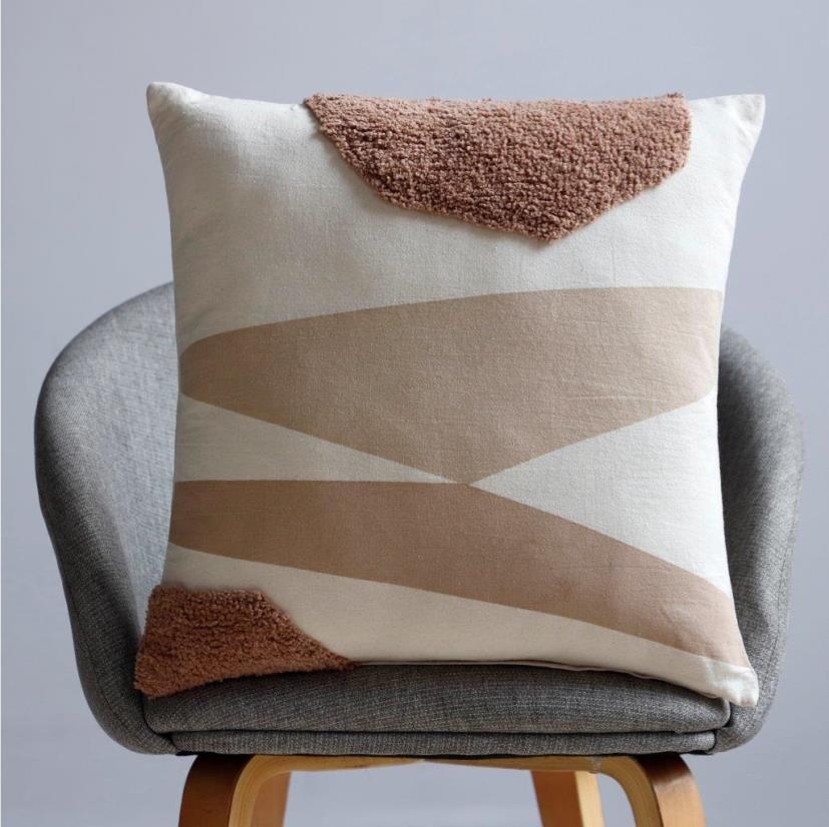 Natural cotton square cushion with geometric landscape design and tufted rust corner accents