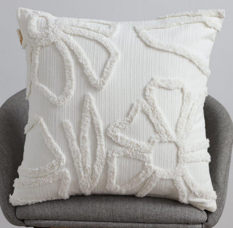 Pure white square cushion with white raised abstract organic tufted shapes